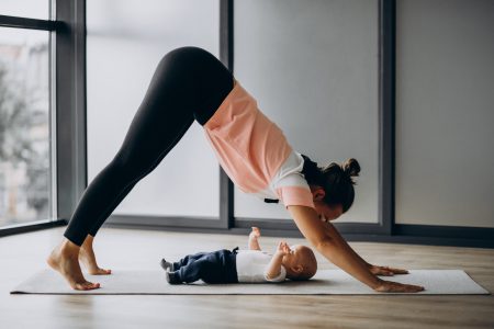 Mother with little baby boy practice yoga